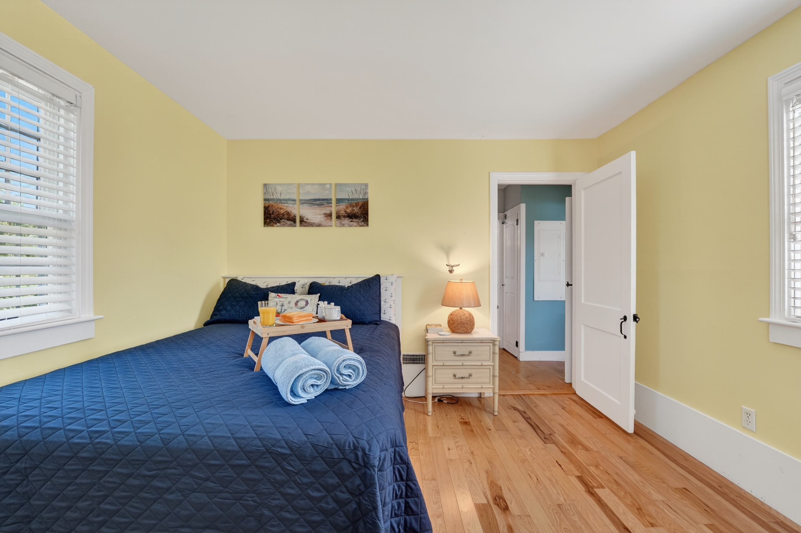 Cheerful guest bedroom with a cozy bed, warm colors, and plenty of natural light.