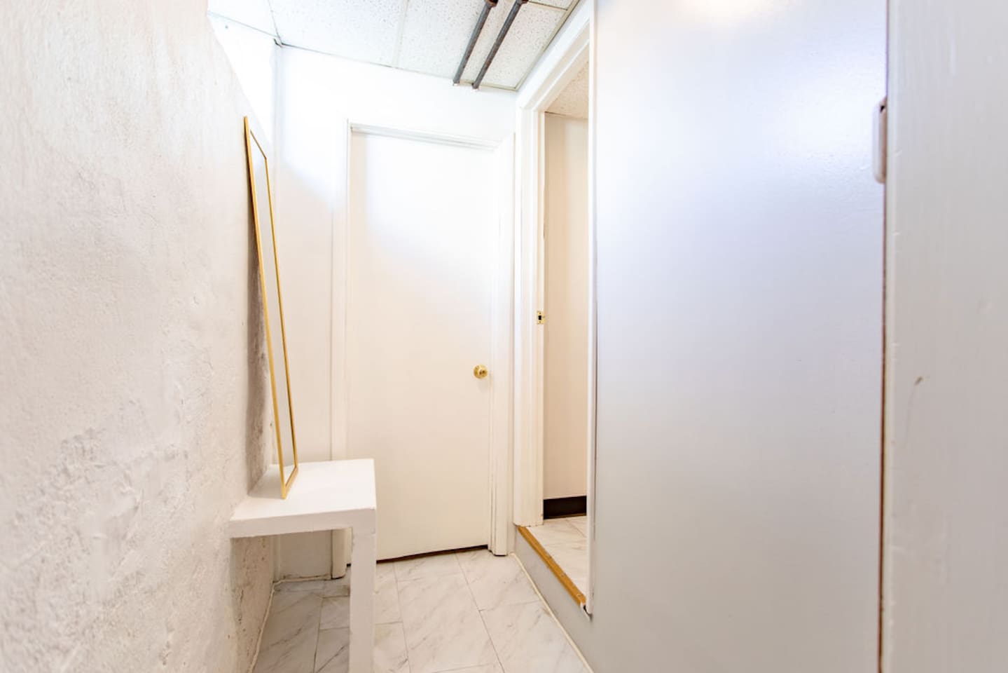 Hallway and dressing area from bedroom to bathroom.