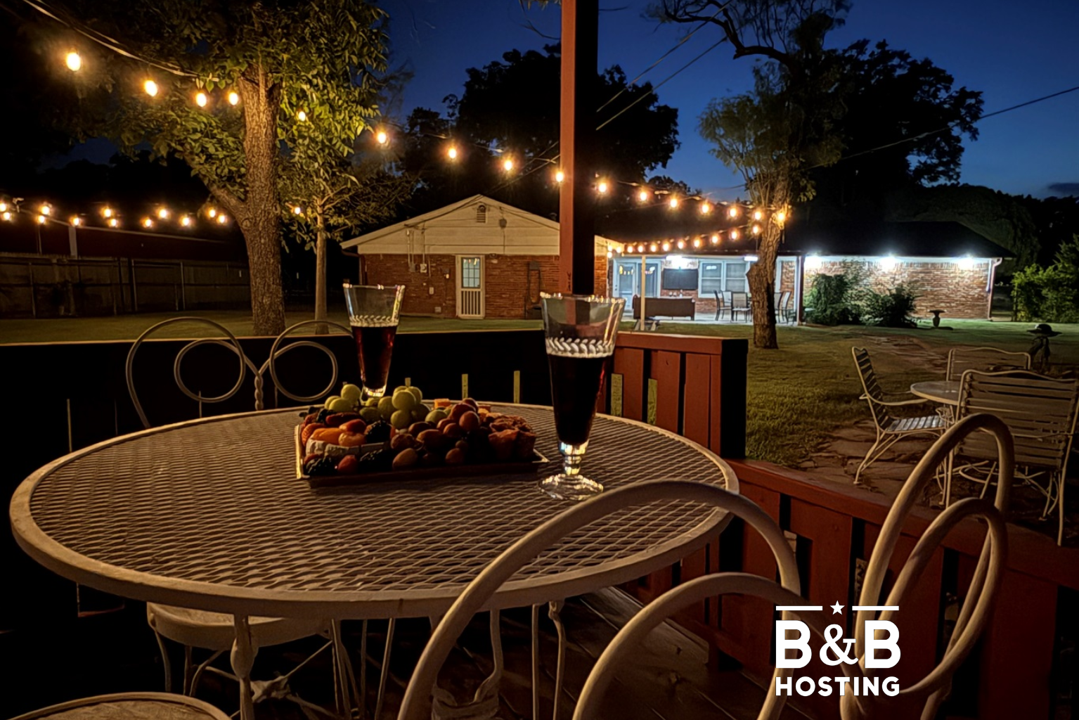 Your private outdoor paradise awaits with multiple entertainment areas, mature shade trees, and magical string lighting for perfect evening gatherings.