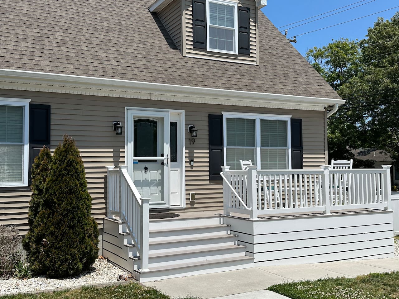 Welcome to the house! This front porch is the perfect spot for morning coffee. It’s such a bright, cheery entrance, and the rocking chairs are just waiting for you to sit back and watch the world go by.