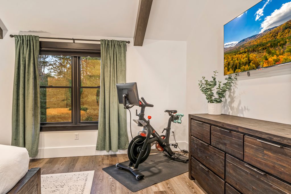 Wake up inspired. ☀️ With vaulted ceilings, soft light, and your own Peloton bike, this space is equal parts retreat and recharge. Start your morning with movement — end it with mountain calm