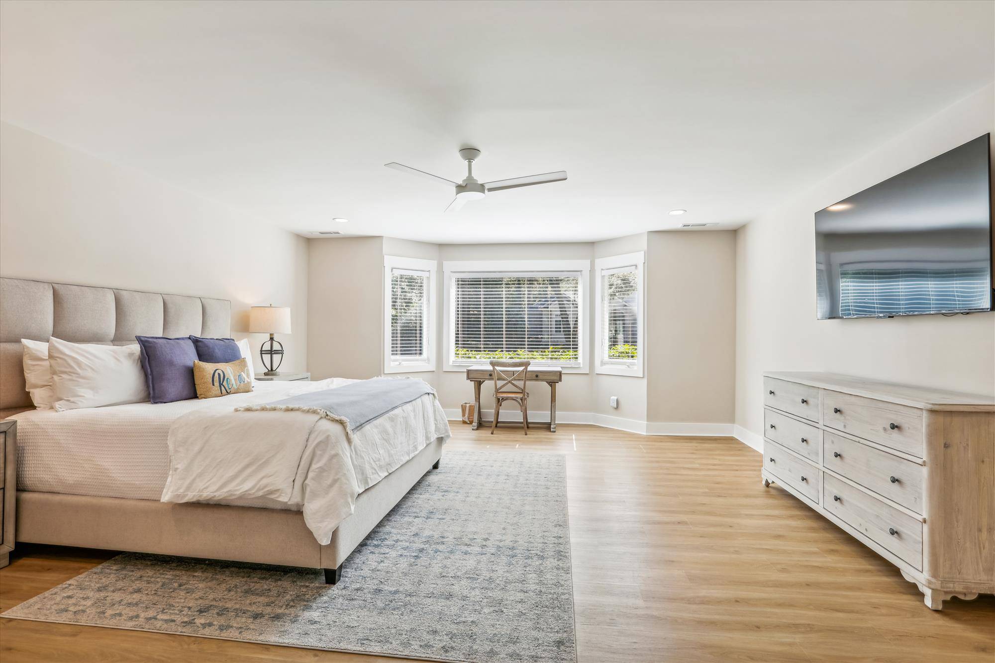 Primary bedroom features a 65" LEDTV