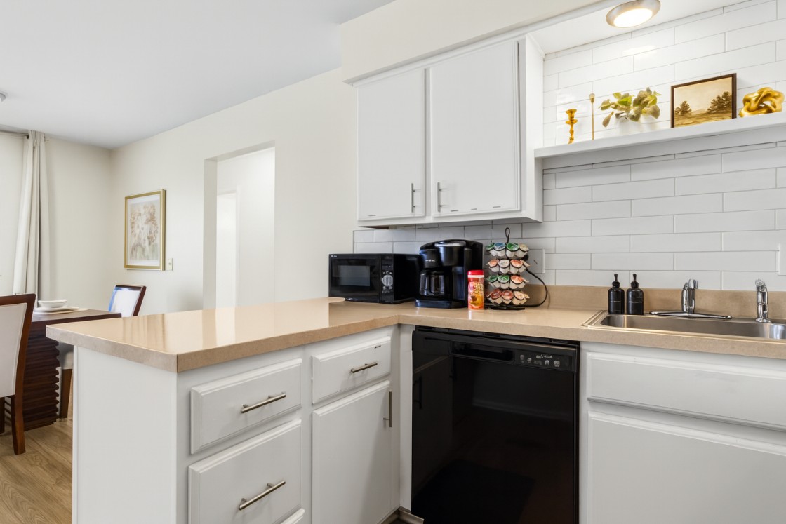 Sleek and modern kitchen with updated appliances, perfect for enjoying meals at home.