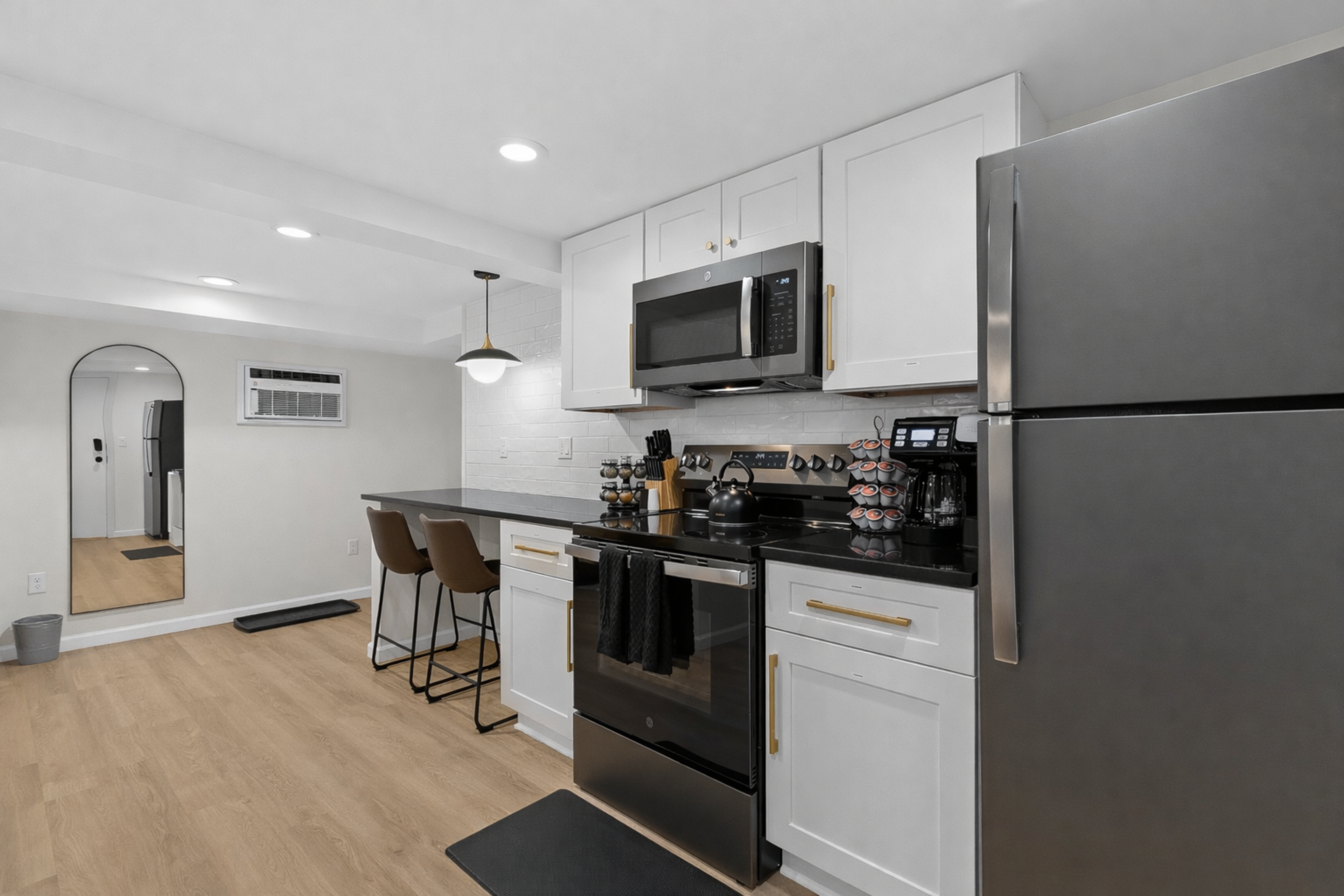 Open, modern kitchen layout with stainless appliances, bar seating, and sleek finishes—perfect for cooking, dining, and enjoying a comfortable stay.