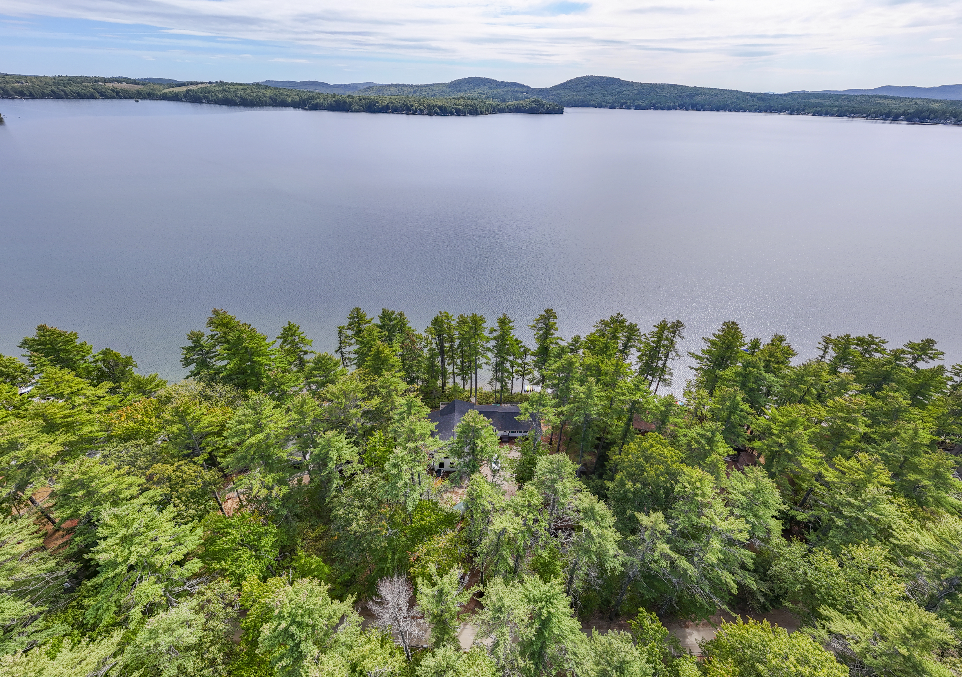 There it is! Your lakefront retreat is tucked among the trees with Great East Lake right outside.