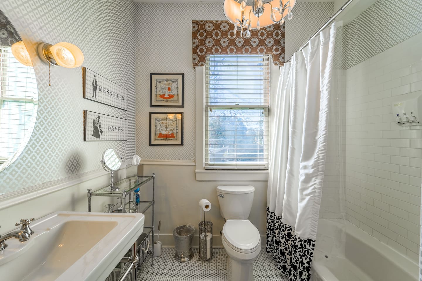 Subway tile Shower/Bath to relax at the end of a fun day. Shampoo, Conditioner and Shower Gel dispenser. Lavish historical feel. 