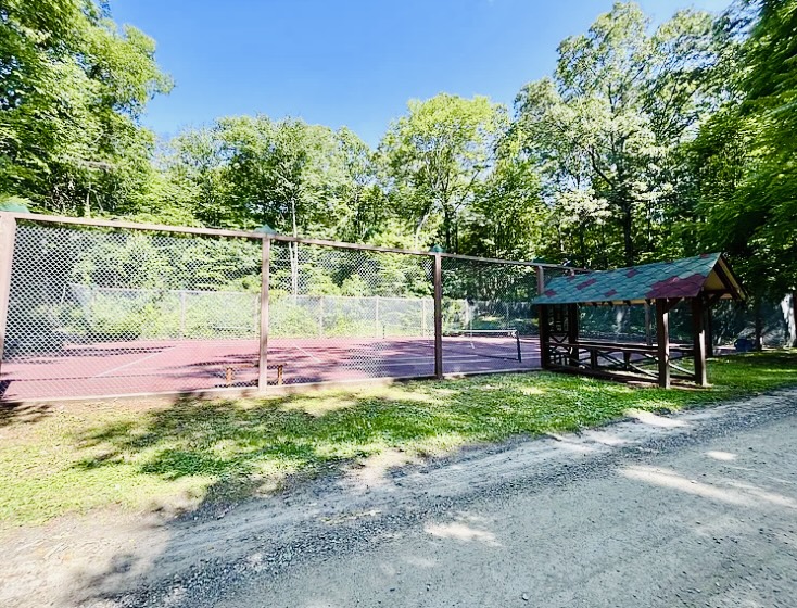Community tennis court and shaded pavilion, just steps away
