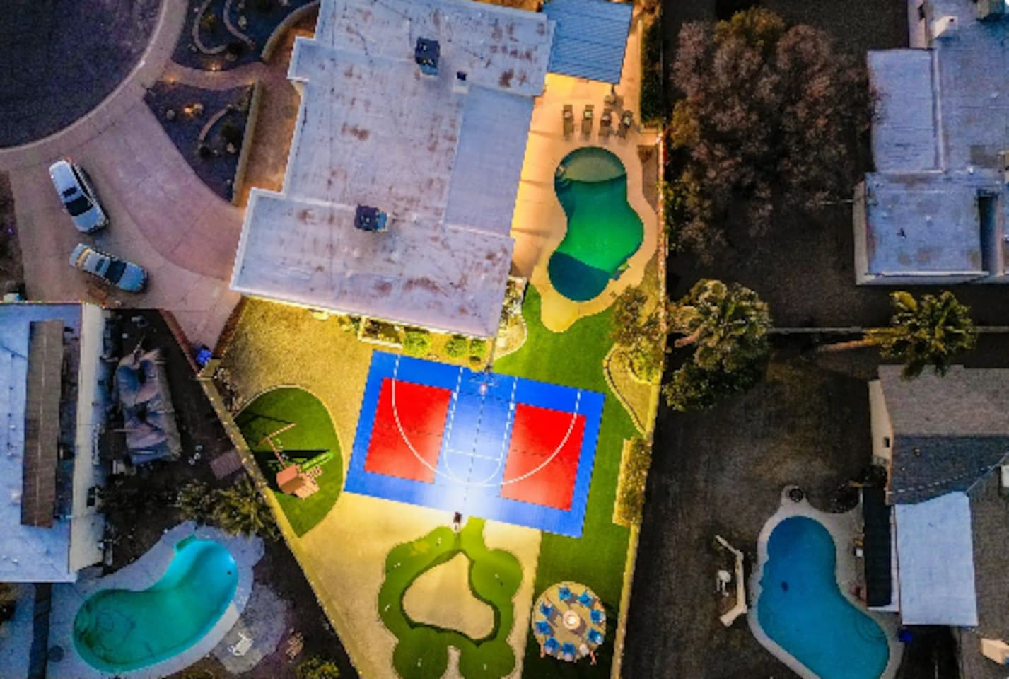 A backyard built for a crowd: pool, sport court, and putting green, all on one oversized lot.