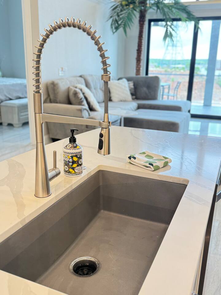 Flexible kitchen sprayer with large deep sink.