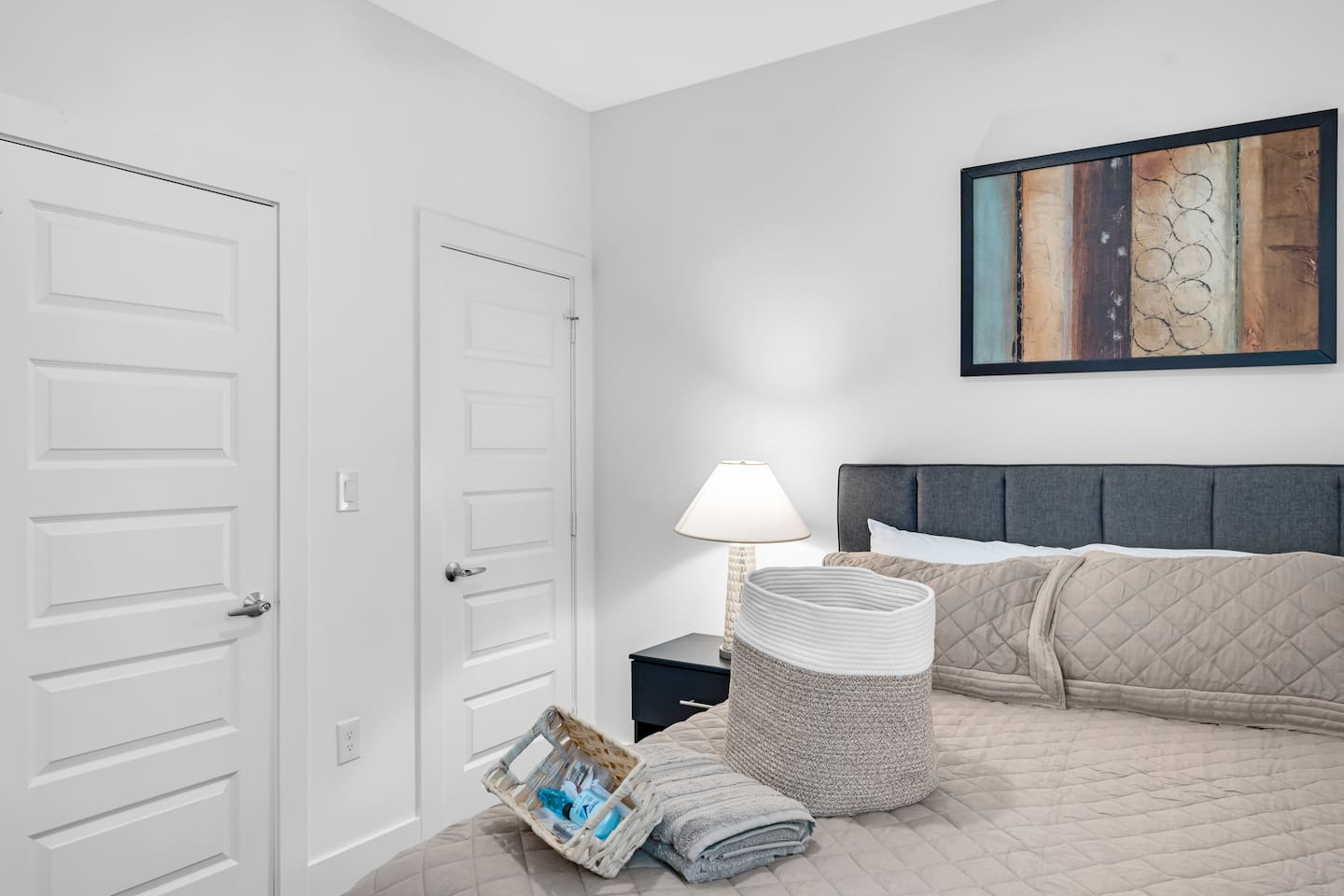 Chic and cozy guest bedroom with a plush bed, soft linens, and calming minimalist decor—ideal for a restful night’s sleep.