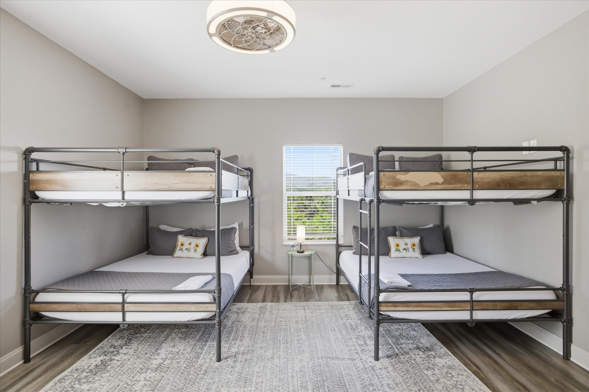 Let this be the late-night hangout zone—movies playing, snacks passed around, and plenty of room for everyone to spread out. With a TV in the room and cozy bedding all around, it’s built for winding down together.