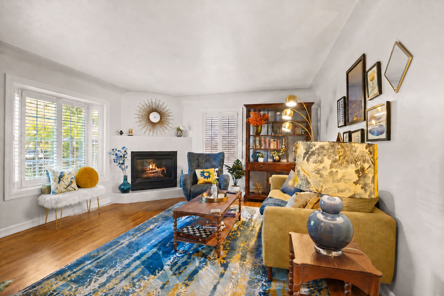 Cozy living room overlooking the front yard, with a 55” TV, record player, and gas fireplace.