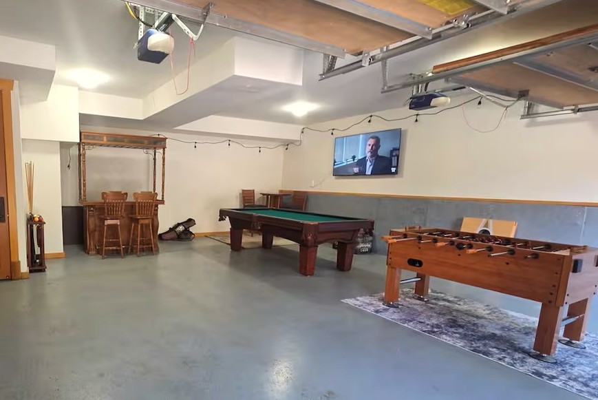 Enjoy friendly competition in the garage game room, complete with a pool table and foosball table