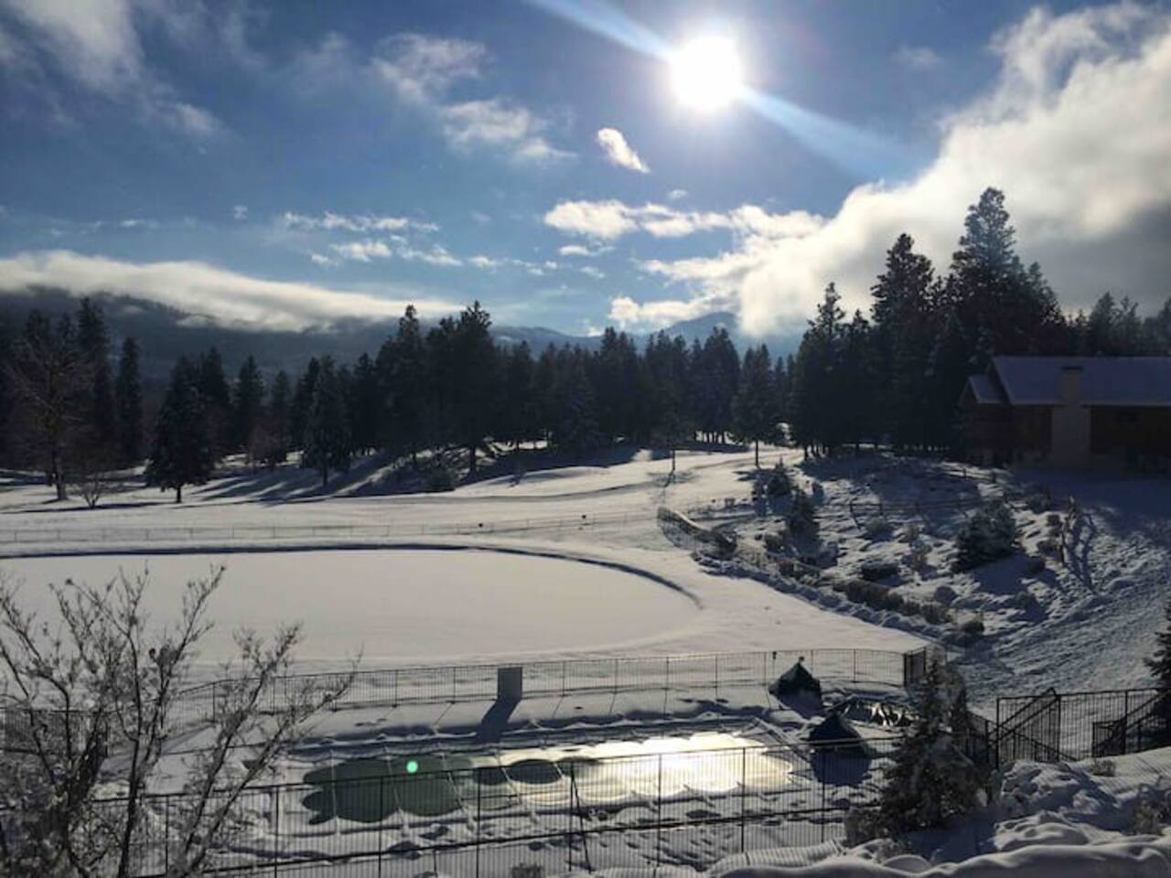 Winter view from the balcony of the pool, pond, and golf course.  You can see cross country skiers on the golf course during the winter.