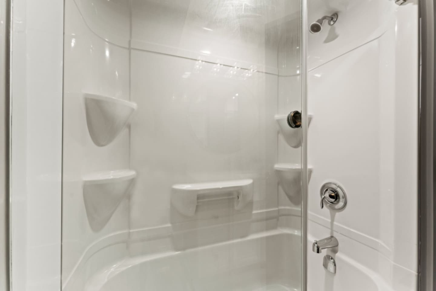 Full Bathroom Frameless glass shower doors emphasize openness.