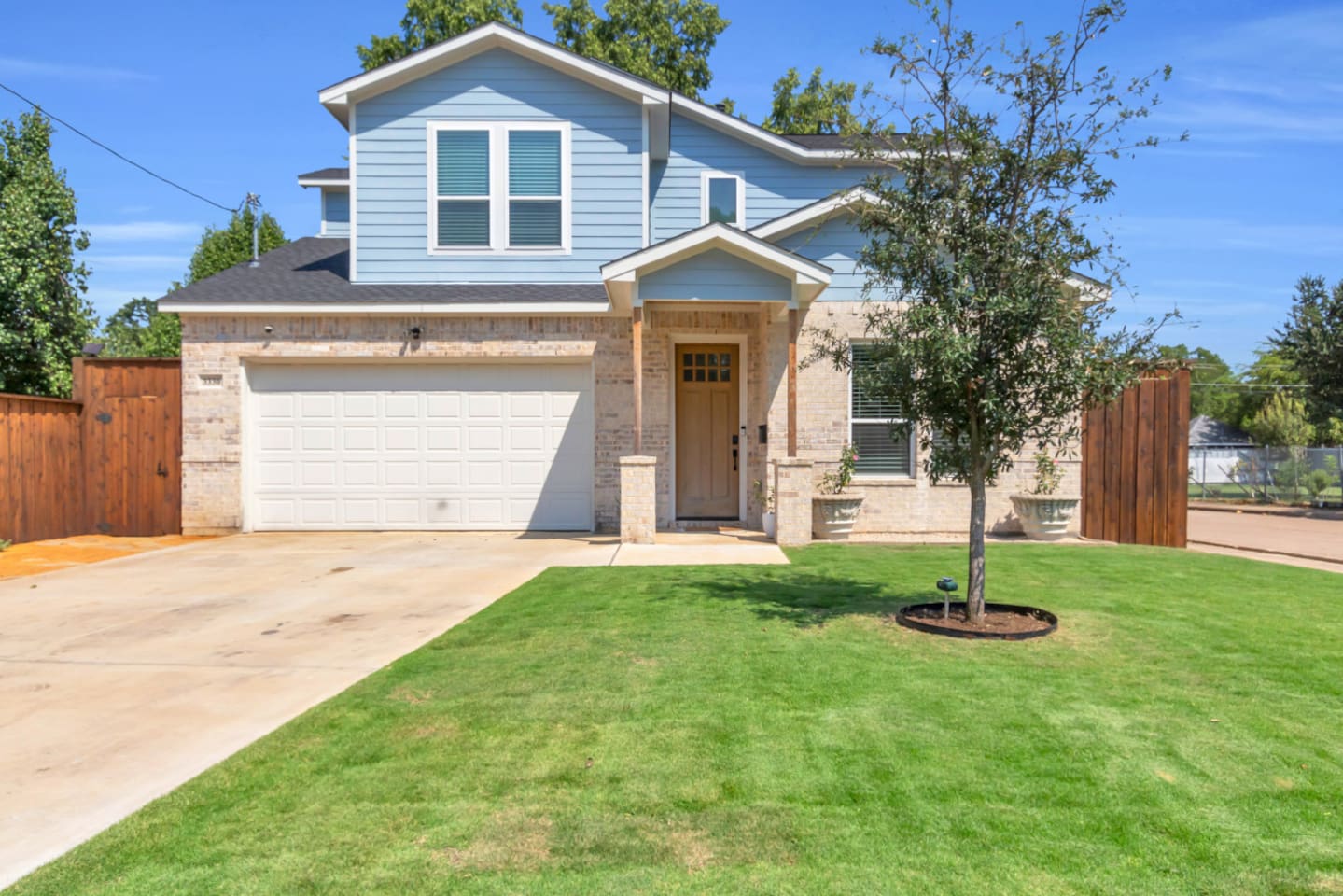 Spacious front yard with 2 car garage and open lawn.