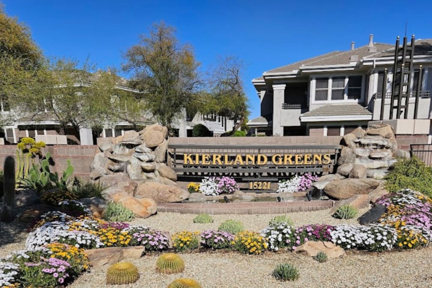 Community entrance sign for Kierland Greens with desert landscaping, flowers
