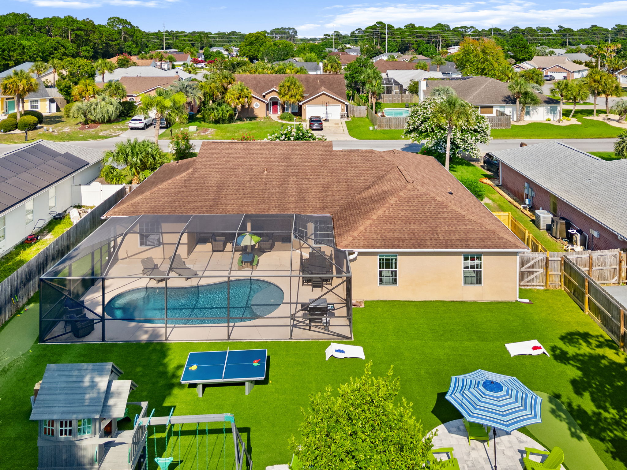 Your private outdoor oasis! 🌴 A breathtaking look at our fully equipped backyard: glowing screened pool, clean artificial turf, 3-hole mini-golf, custom playset, and endless lawn games. The perfect setting for your next getaway!