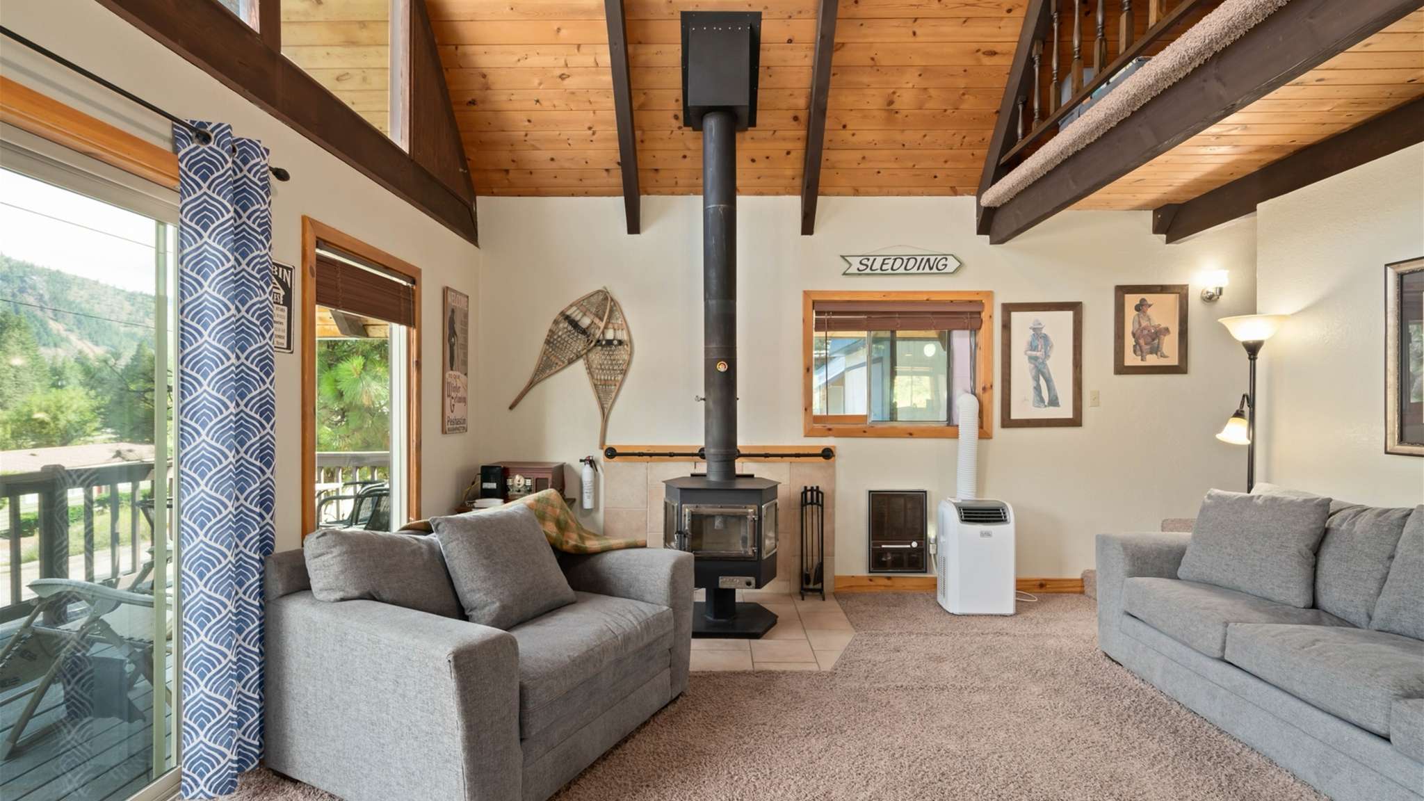 Cozy living area with woodstove — ideal for curling up after a day of adventure.