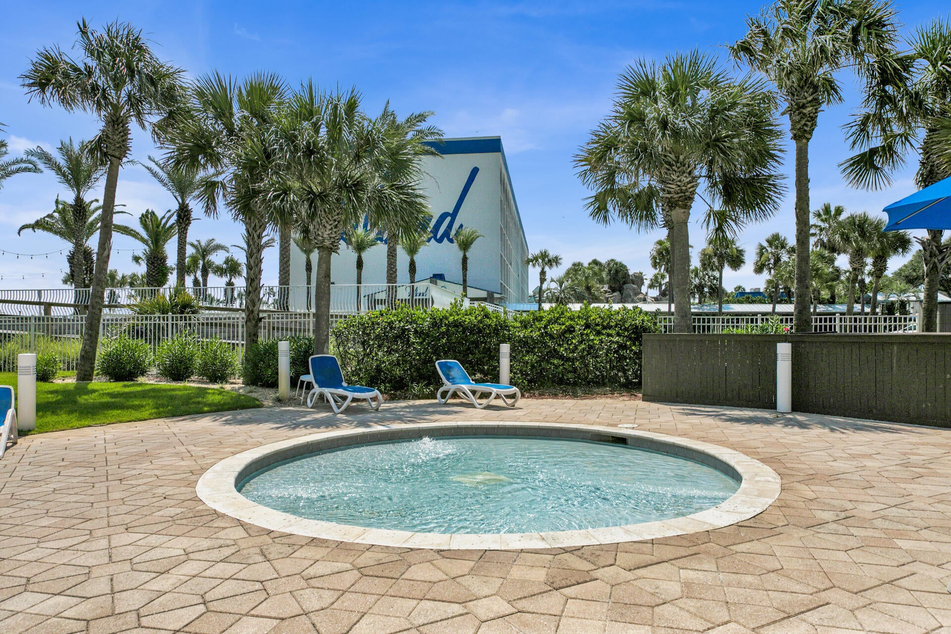 Hot tub tucked among greenery, ideal for a relaxing soak anytime.
