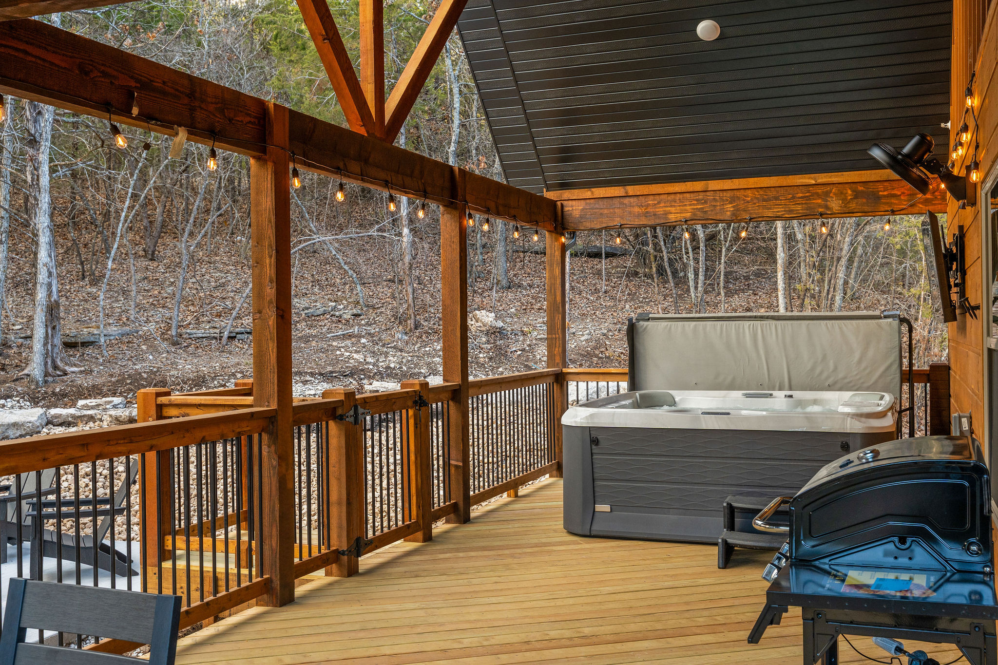 A relaxing spot on the deck with the hot tub nearby.