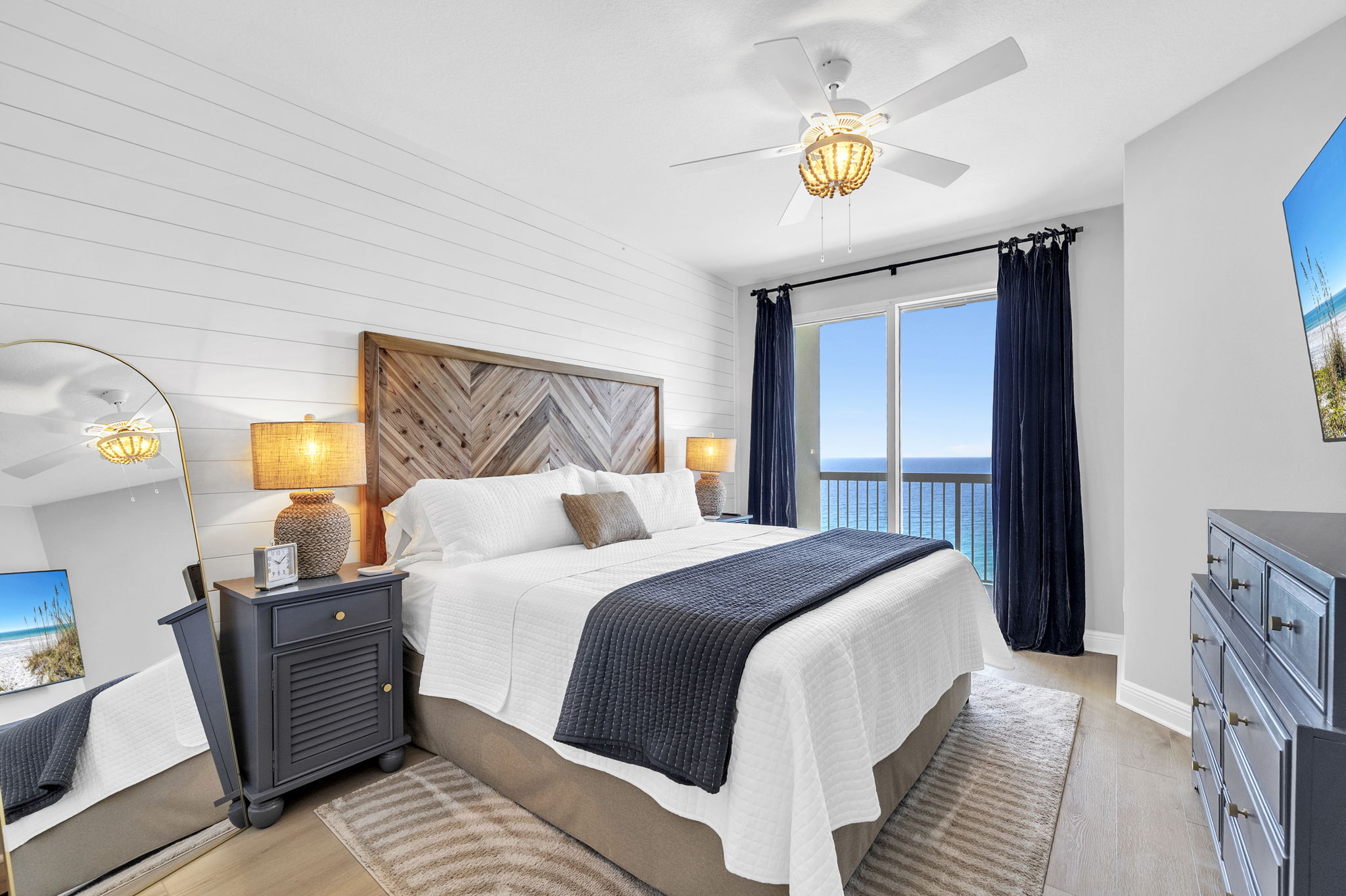 Wake up to breathtaking Gulf views in this serene primary bedroom with en suite, featuring a plush king bed, cozy linens, and direct balcony access—perfect for relaxing after a day at the beach.