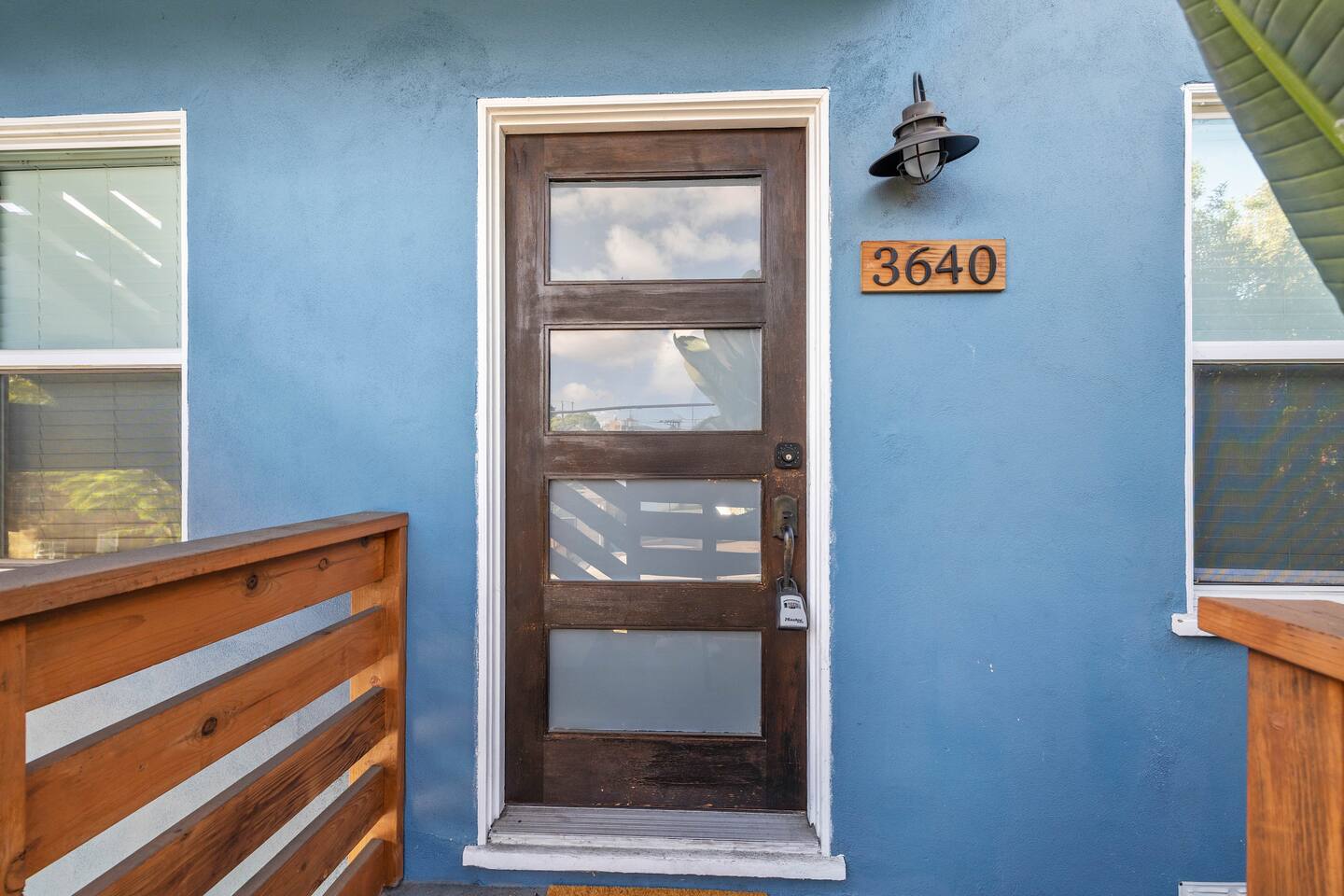 The exterior welcomes you with a sleek, modern door that leads inside, setting the tone for a stylish stay. Clean lines and contemporary design create a warm yet sophisticated entrance to your retreat.