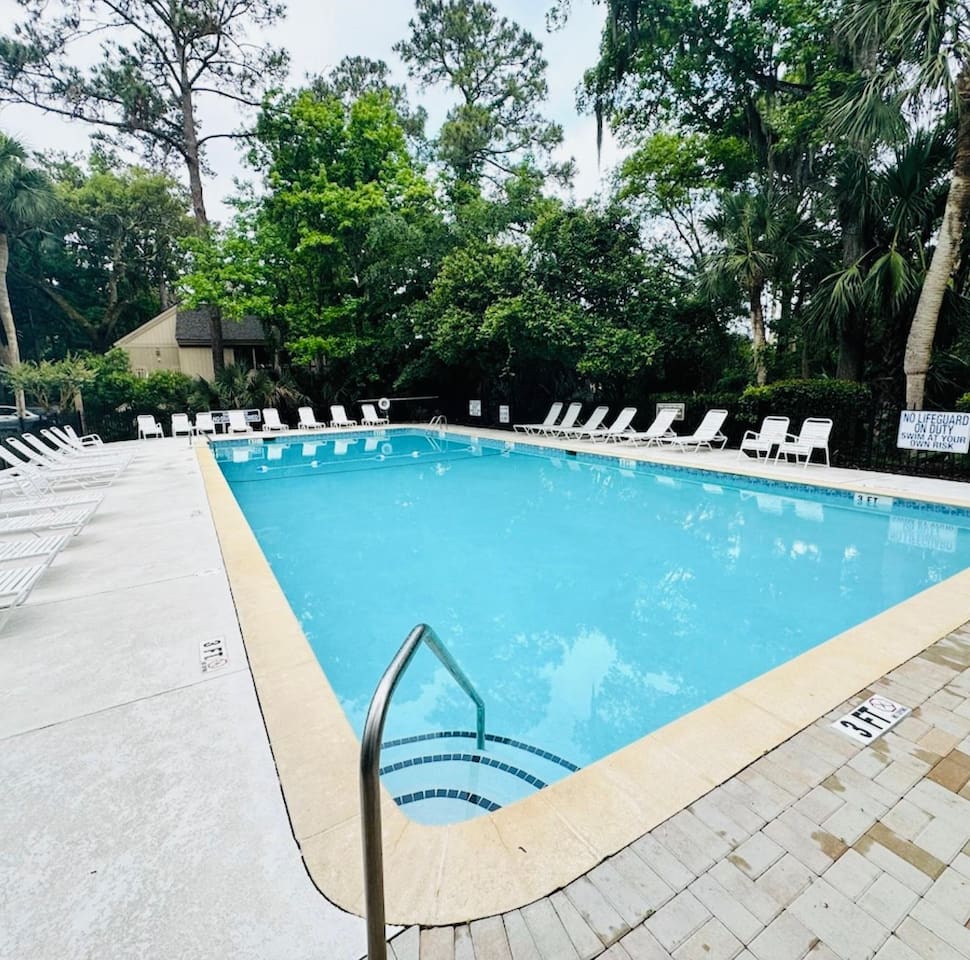 Community pool with lounge chairs