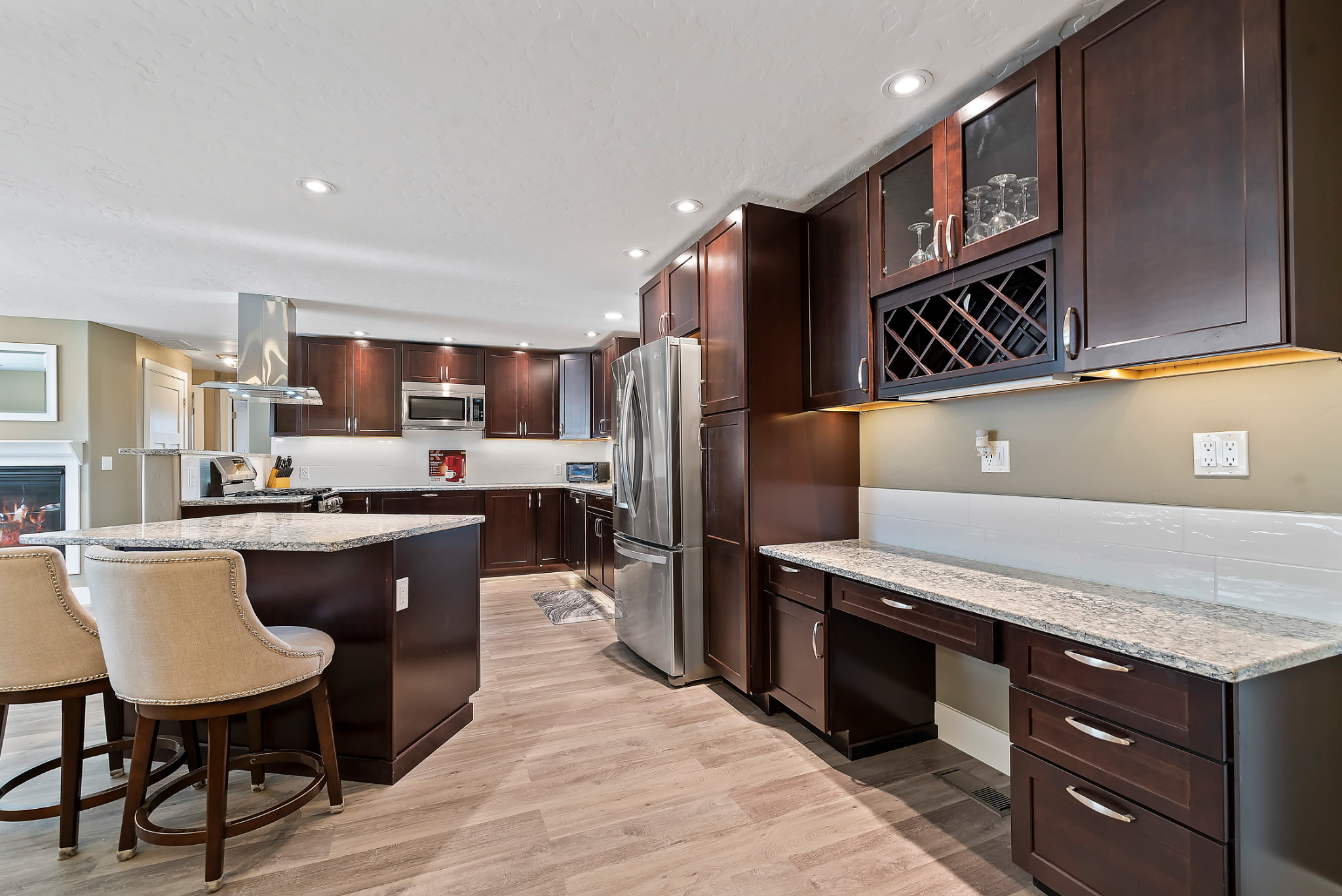 Upgraded kitchen with a built-in desk space perfect for working or gaming, complemented by overhead lighting for a bright and comfortable setting.
