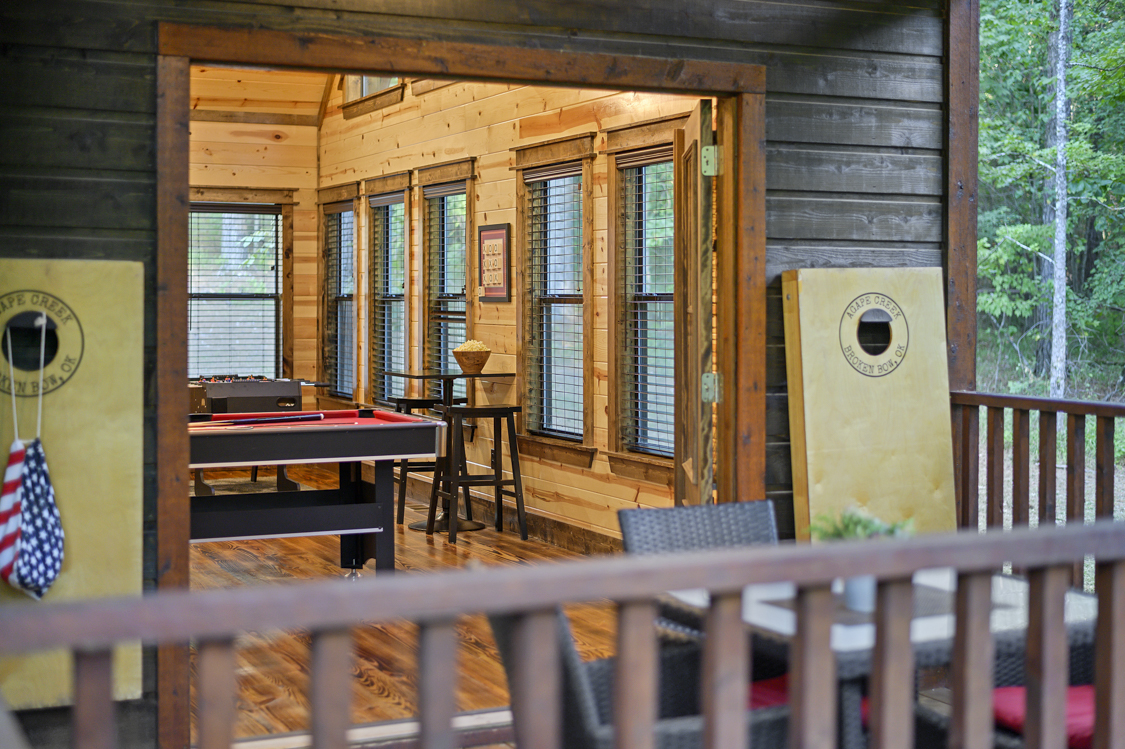 French doors lead to oversized back deck from the game room.