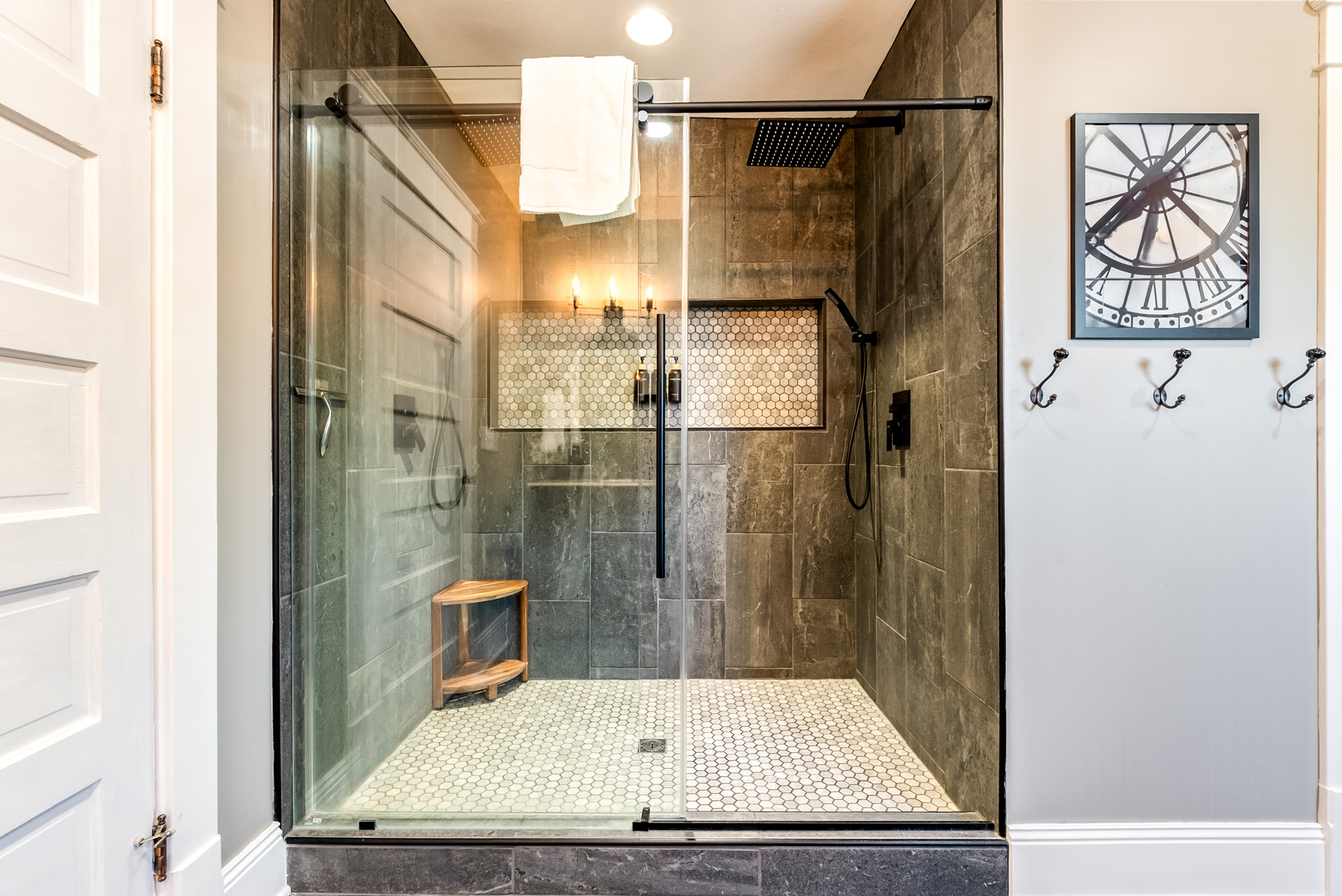 Wash the beach sand away in style. The custom ensuite bathroom features a stunning walk-in shower with floor-to-ceiling tile, seamless glass, and a luxury rainwater showerheads