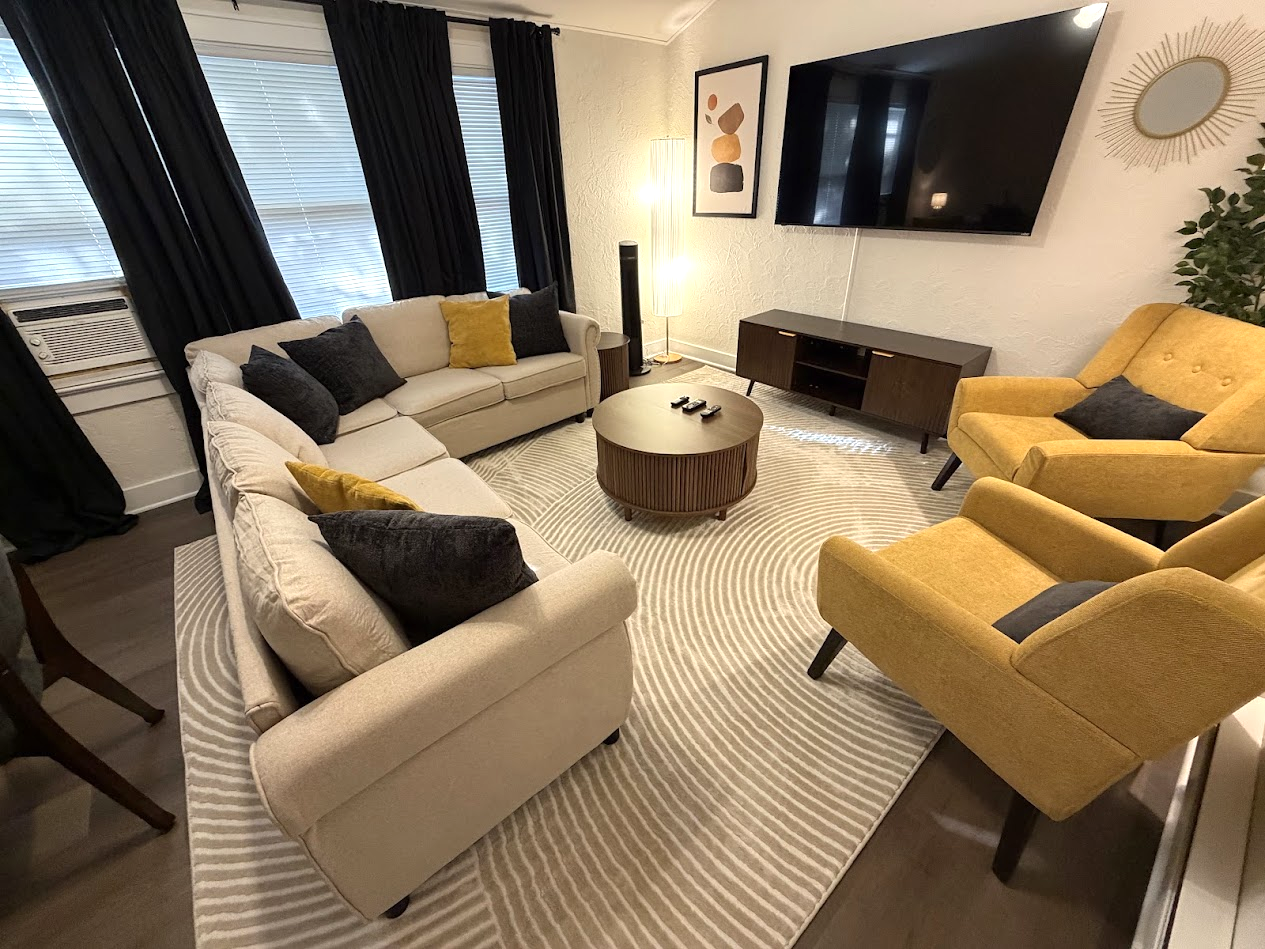 Living Area w/ 65" Smart TV and pull-out sofa bed