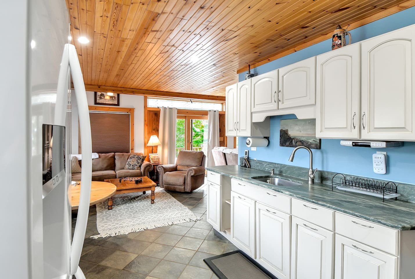The kitchen in the second home comes stocked with a dishwasher, stove, big fridge, and ready for your family meals! 