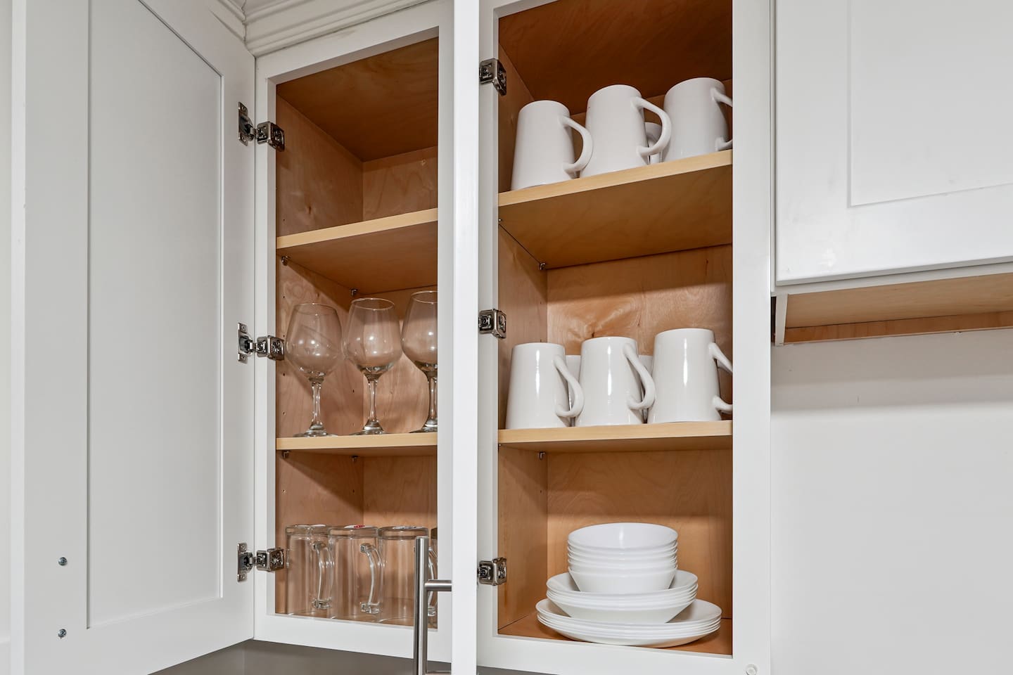 Full kitchen thoughtfully stocked with everything you may need including cookware, utensils, dishes, and essential appliances perfect for preparing meals and enjoying a true home-away-from-home experience.