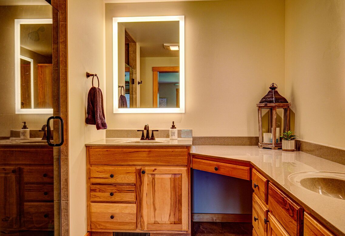 Primary ensuite with walk in shower and double vanities.