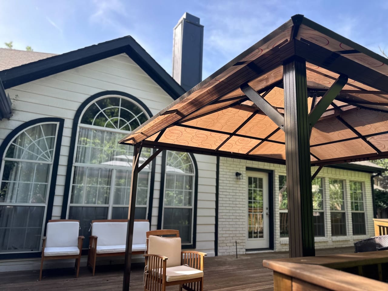 Spacious backyard with privacy fence, large deck, and BBQ grill.
