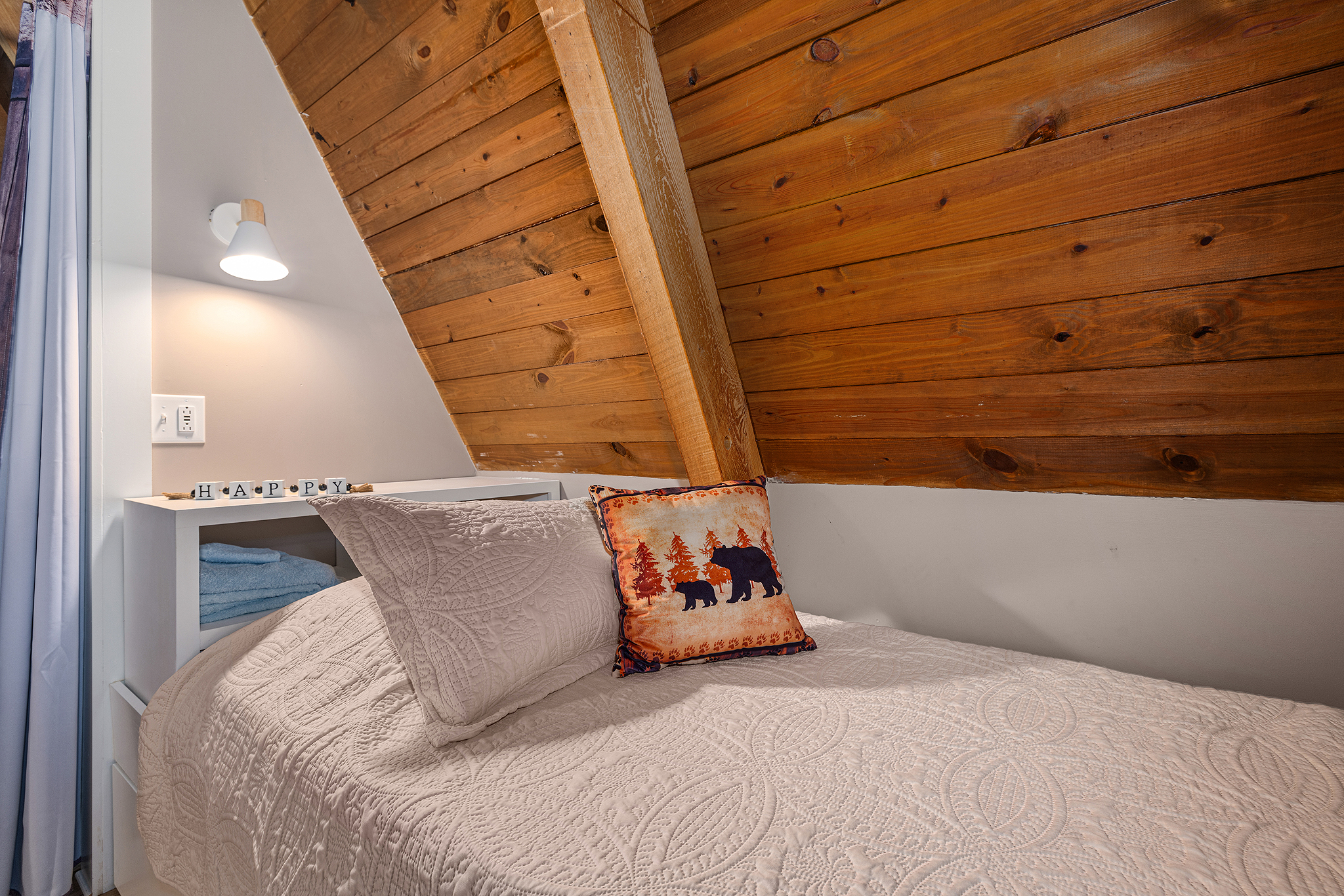 A shelving surface at the head of each twin is great for personal items.