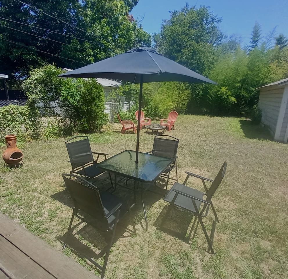 Two seating areas in the large fully fenced backyard - one area for seating and a second around the firepit. 