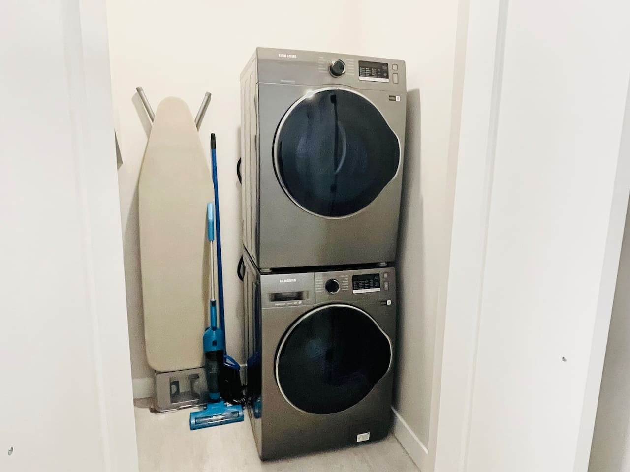 Brand new Samsung, Stackable Washer and Dryer. Also, ironing board and vacuum kept in Laundry Area. 