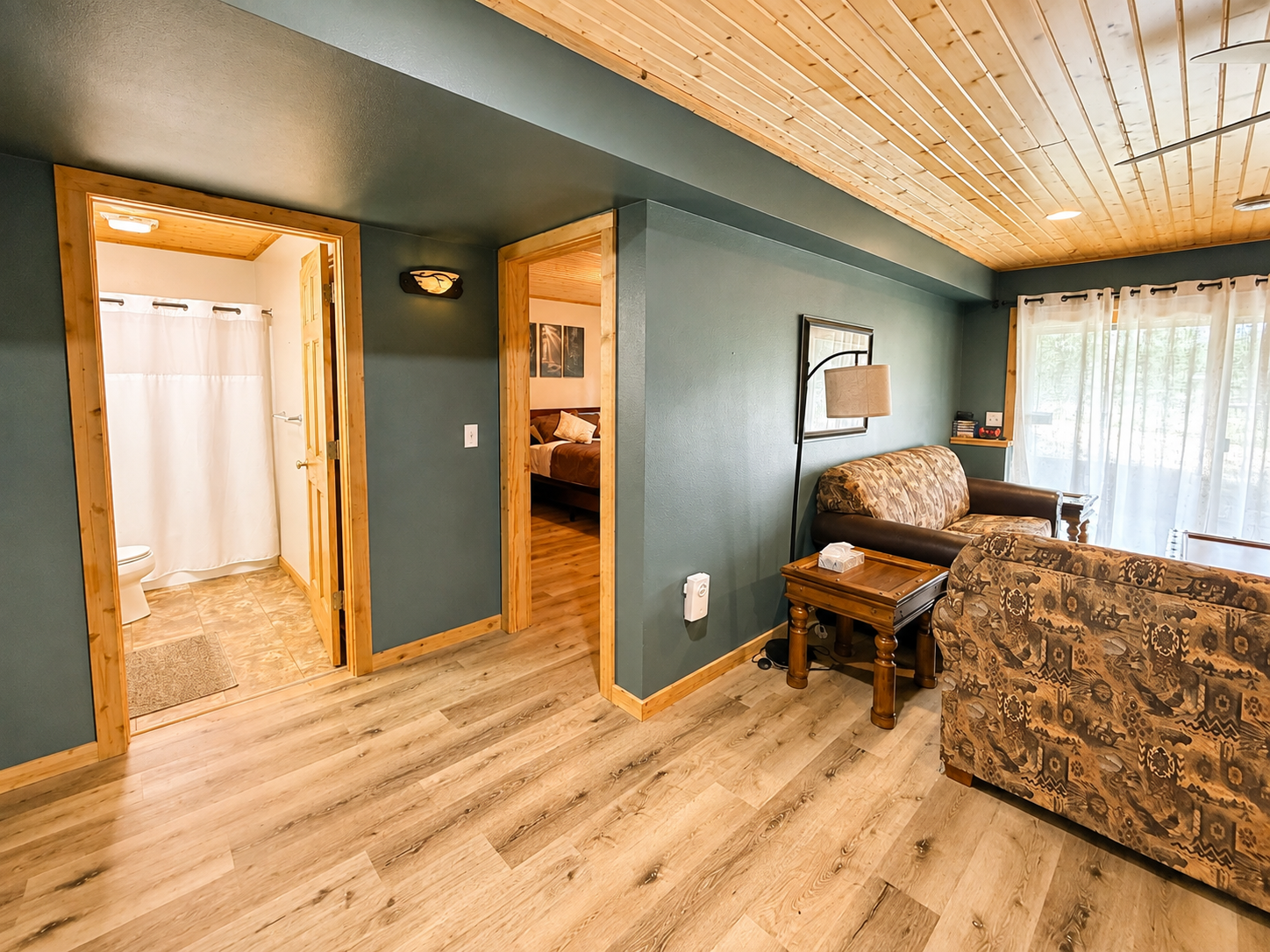 Convenient basement layout with a living room, nearby bedroom, and full bathroom, great for a family or part of the group to have their own comfortable space downstairs.