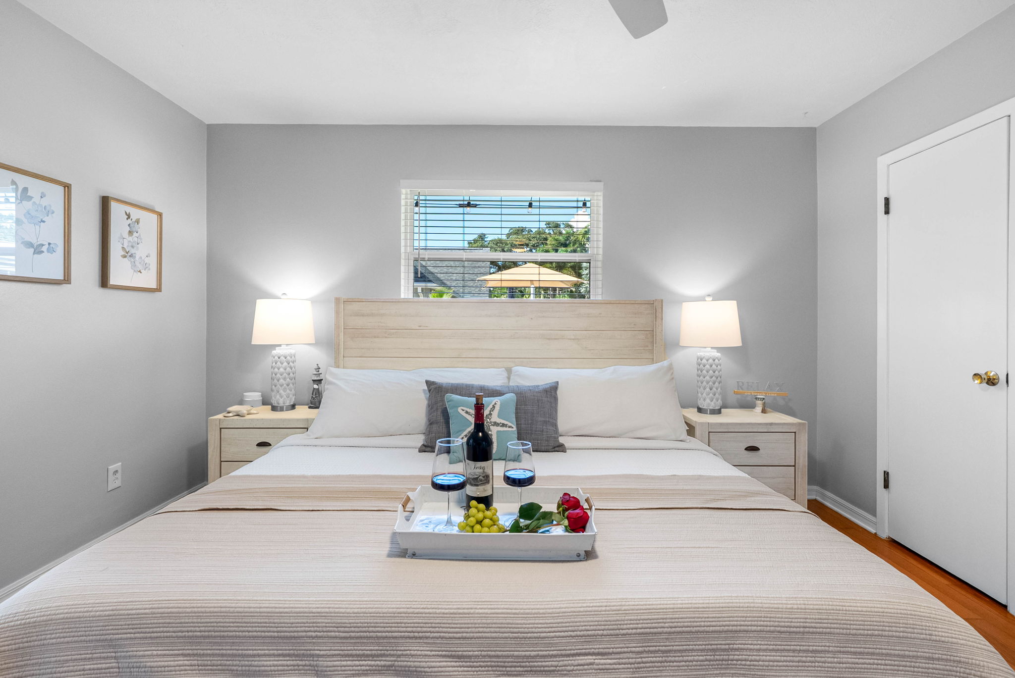 Retreat to the master bedroom, where a plush king mattress, modern ceiling fan, and calming decor invite pure relaxation.