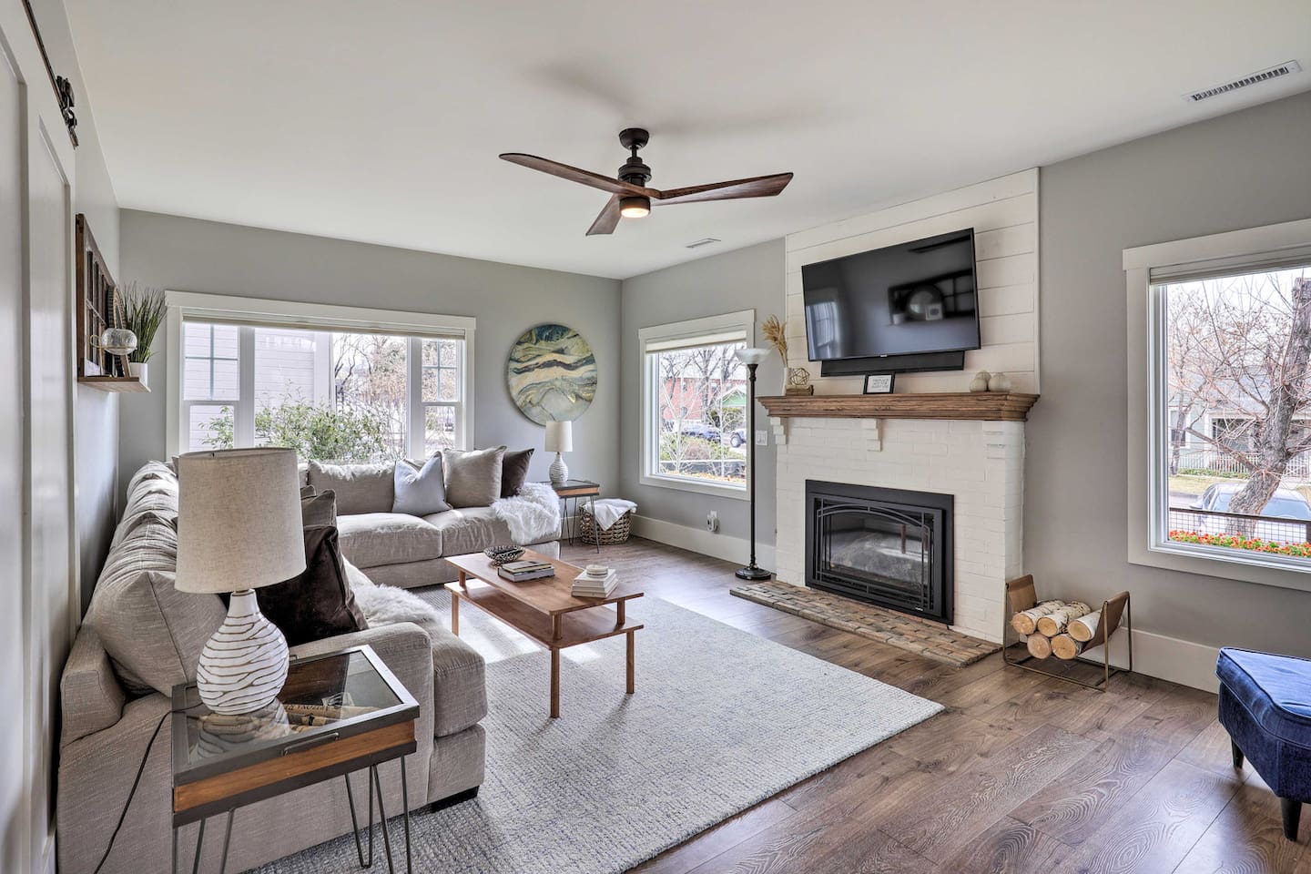 Big windows keep this space bright all day, with the fireplace ready for cooler evenings.