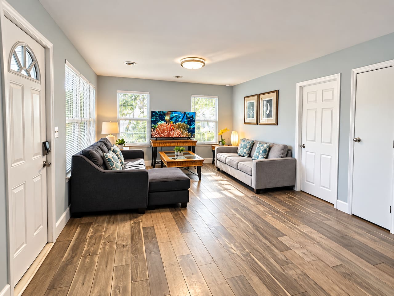 Living Room: Open space with 50 inch TV, perfect for laughter and relaxation after beach days!