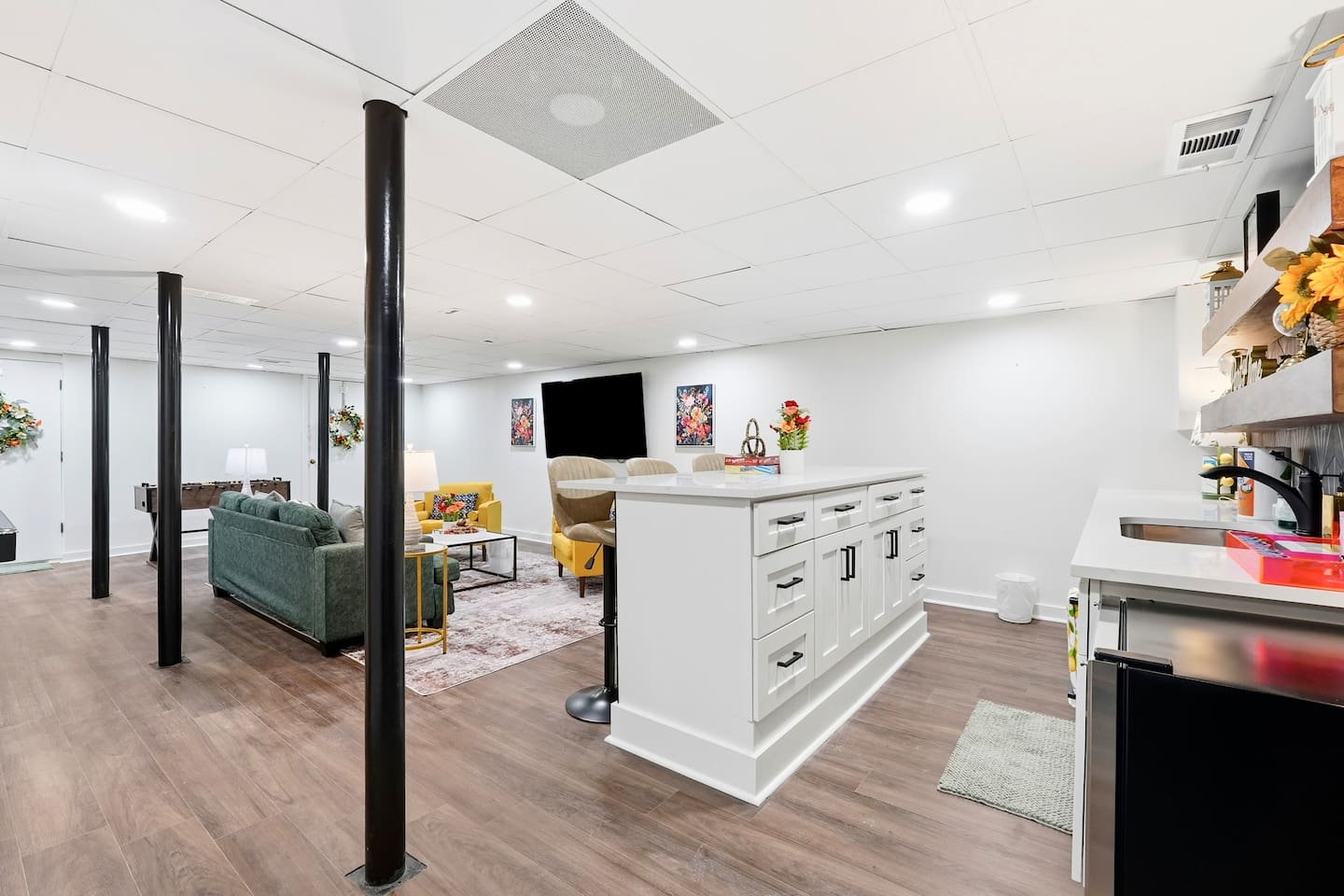 Amazing game room located in the basement, featuring a pool table, foosball table, and a stylish bar perfect for entertaining and relaxing with friends and family.