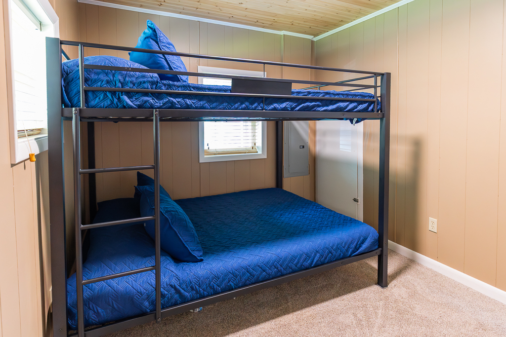 Rest easy in this comfy bunk room, perfect for relaxing after a day at the lake.