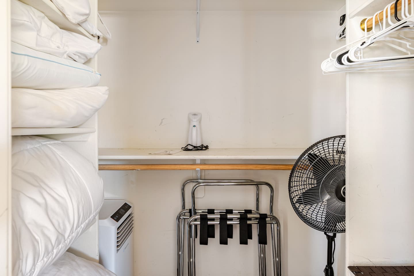 Spacious master closet with plenty of hangers, extra pillows, two luggage racks, and portable air conditioner for those scorching Scottsdale summer days!