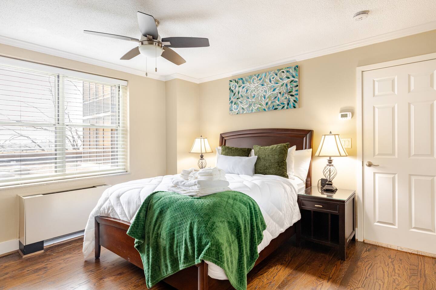 Comfortable guest room w/ large window & cozy bedding.