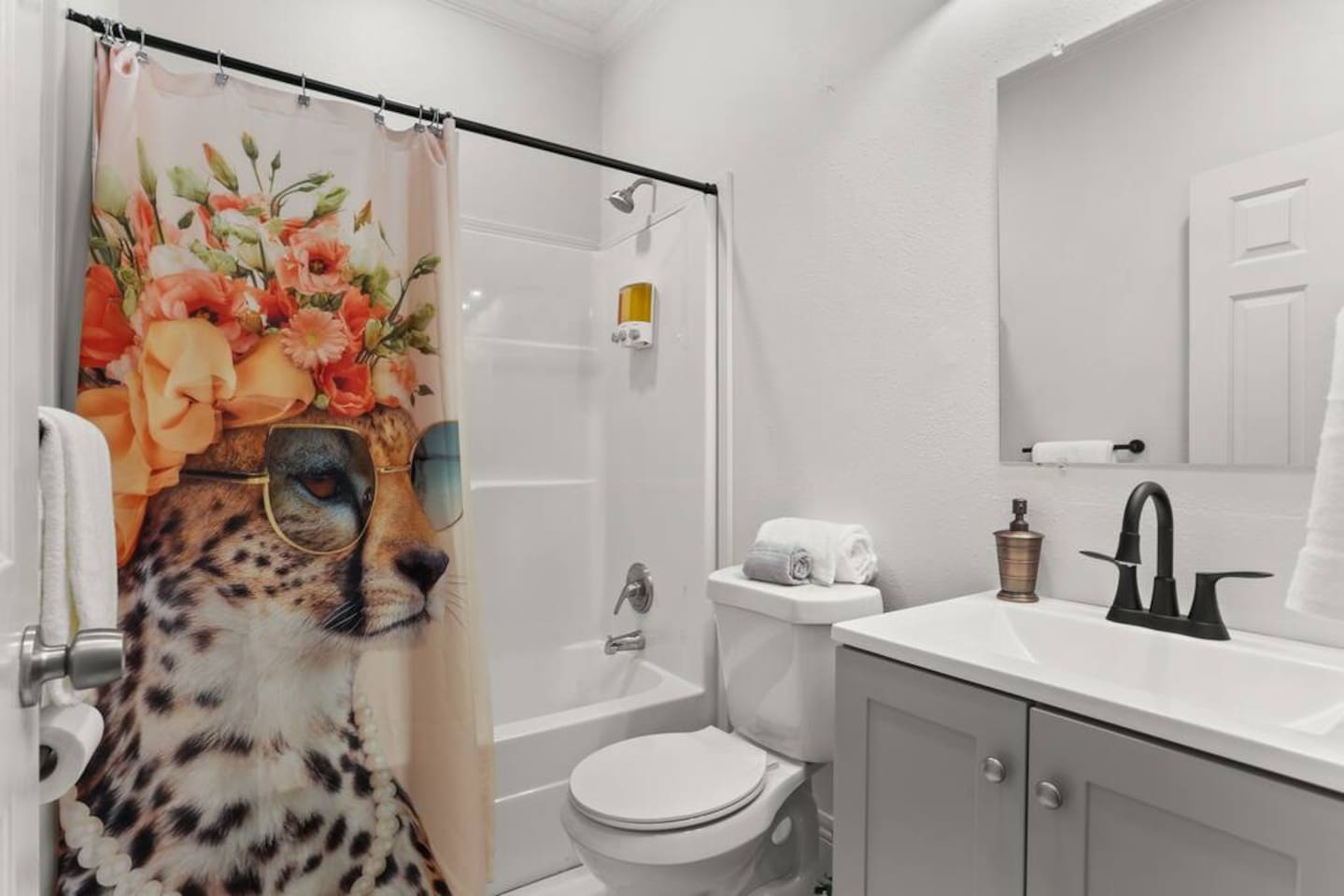 The en suite master bathroom features a tub/shower combo, shampoo, conditioner, & body wash, hair dryer, and plenty of towels.  