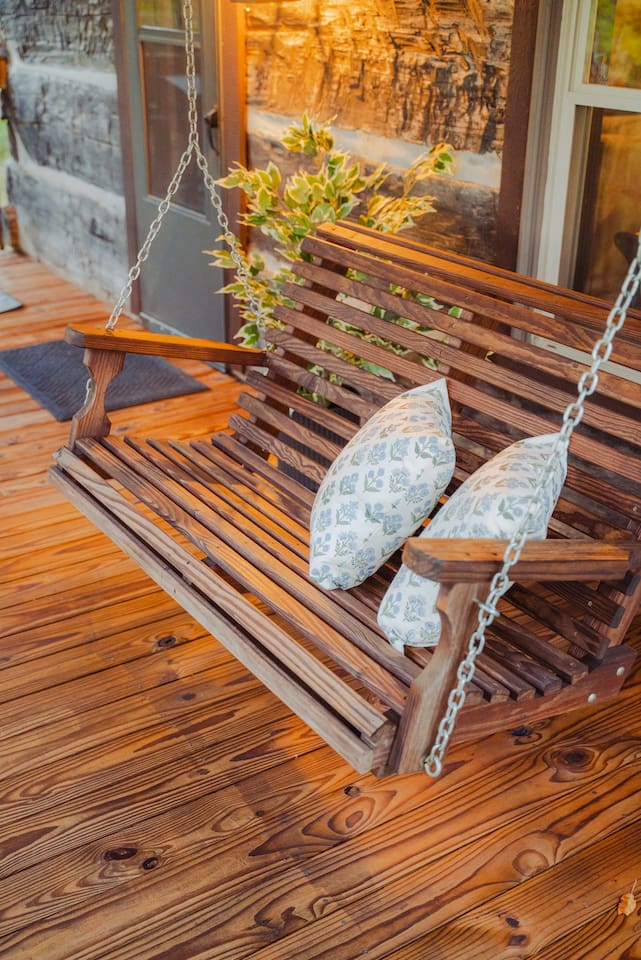 Swing into relaxation on the porch swing, surrounded by calm and nature.