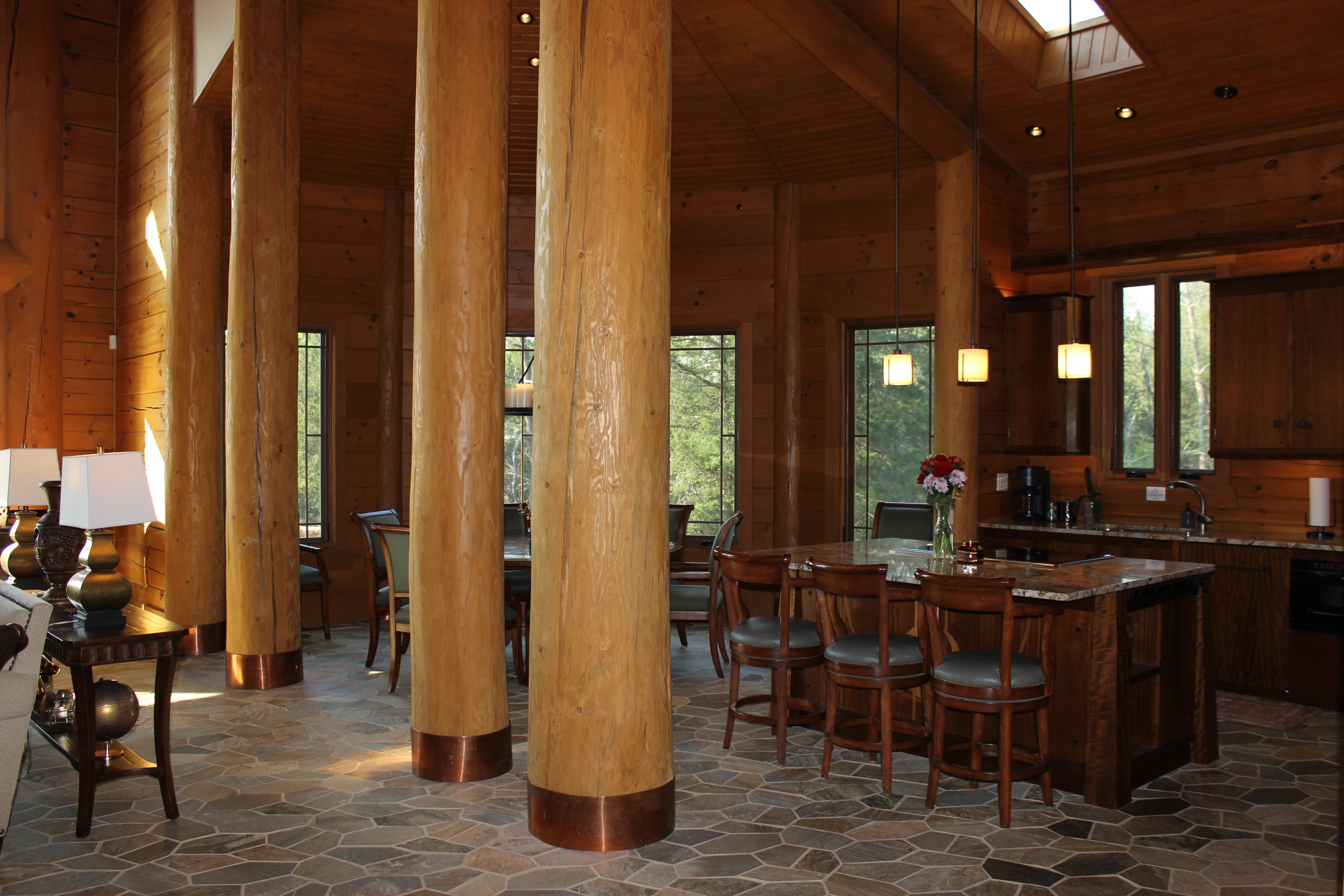 Kitchen view with dining area and large island with three bar stools.